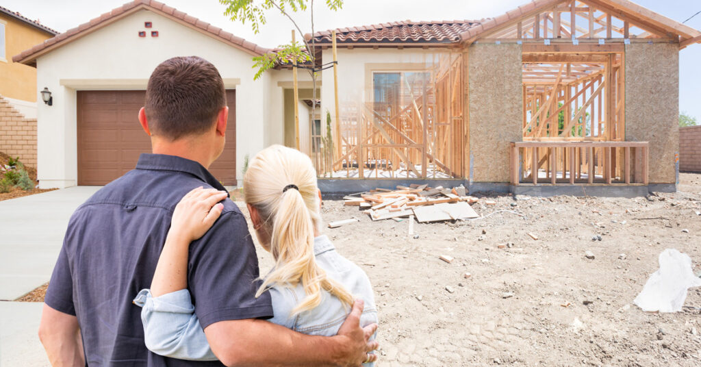 Couple Looking at Home Construction Outside Wondering How to Finance Home Renovation